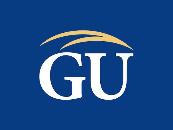 The image shows a blue logo with the white capital letters "GU" and a gold swoosh above them. The background is solid blue.