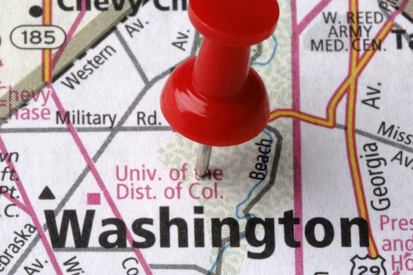 The image shows a map with a red pushpin marking the location of Washington, D.C., including nearby streets and landmarks.
